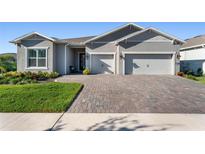 Beautiful single-Gathering home with a welcoming front porch, large driveway, and a two-car garage at 6535 Shimmering Shores Ln, St Cloud, FL 34771