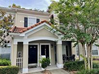 Inviting two-story condo with a private patio entryway nestled among lush landscaping at 923 Arbor Lakes Cir # 923, Sanford, FL 32771