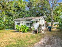 Quaint home with green awnings, landscaping, and a welcoming front porch at 3109 Williams St, Orlando, FL 32806