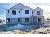 Two-story house under construction, block walls, and roofing installed at 977 Hawksnest Pt, Oviedo, FL 32765