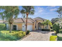 Charming single-story home with tile roof, lush landscaping, and a paver driveway at 11840 Eagle Ray Lane, Orlando, FL 32827