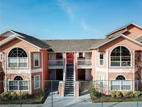Attractive two-story condo building with balconies and stairs at 8711 Rockingham Ter # D, Kissimmee, FL 34747