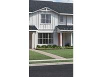 Charming two-story home with a welcoming front porch and landscaped yard at 1691 Eaglehurst Ln, Apopka, FL 32703