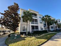 Inviting condo building with lush landscaping and ample parking at 3300 Whitestone Cir # 306, Kissimmee, FL 34741