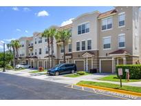 Modern townhouses with attached garages and palm trees at 8001 Cool Breeze Dr # 121, Orlando, FL 32819