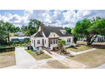 Charming two-story home with a brick and stucco exterior, landscaped yard, and driveway at 1413 Dorothy Ave, Haines City, FL 33844