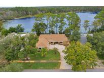 Beautiful home on a lakeside lot with lush landscaping and mature trees at 3966 Lake Mira Dr, Orlando, FL 32817