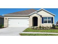 Charming single-story home with a two-car garage and landscaped front yard at 2109 Pigeon Plum Dr, Haines City, FL 33844