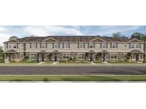 Attractive row of townhouses with gray siding, dark shingle roofs, and landscaped yards at 2765 Flushing Dr, Apopka, FL 32703