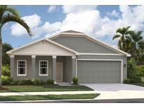 Charming single-story home with a gray exterior, white trim, and a two-car garage at 5710 Cattle Ranch Dr, Saint Cloud, FL 34771