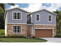 Two-story home with stone and siding exterior, attached garage, and landscaped front yard at 33287 Country House Dr, Sorrento, FL 32776