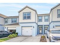 Two-story townhome with white double garage doors at 3780 Plainview Dr, Orlando, FL 32824