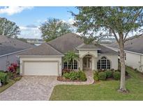 Single-story home with a paved driveway and landscaping at 3528 Chapel Hill Blvd, Clermont, FL 34711