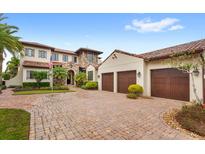 Luxury home with three-car garage, brick driveway, and Mediterranean style at 10200 Carthay Dr, Golden Oak, FL 32836