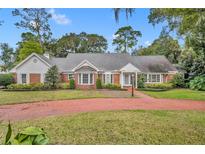 Brick home with a large front yard and circular driveway at 585 Via Lugano, Winter Park, FL 32789