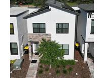 Modern two-story home with solar panels and stone accents at 212 Villa Domani Cir, Davenport, FL 33896