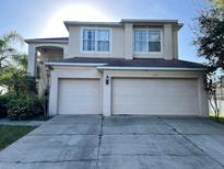 Two-story house with a two-car garage and a well-maintained lawn at 1005 Chase Dr, Winter Garden, FL 34787