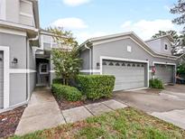 Attractive exterior of townhome with two-car garage and landscaped walkway at 1542 Travertine Ter, Sanford, FL 32771