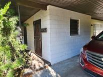 White block house with a dark door and small windows at 1701 N Hastings St, Orlando, FL 32808