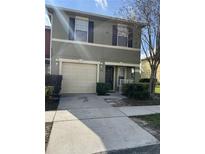 Two-story house with attached garage and landscaping at 572 Cresting Oak Cir # 19, Orlando, FL 32824