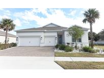 Two-story house with white exterior, three-car garage, and landscaped front yard at 3449 Michigan St, Lake Mary, FL 32746
