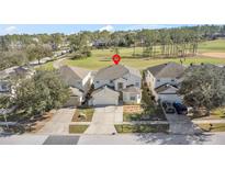 Two-story house with golf course views and a two-car garage at 128 Higher Combe Dr, Davenport, FL 33897
