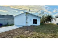 Newly constructed home with modern facade and concrete driveway at 314 N 6Th St, Haines City, FL 33844