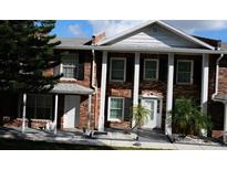 Brick front of a two-story townhome with a covered entryway at 5850 Cypress Gardens Blvd # 304, Winter Haven, FL 33884