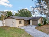 House exterior featuring a carport and well-manicured lawn at 7307 Blair Dr, Orlando, FL 32818