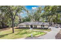 Single-story home with a large yard and a long driveway at 1660 Killean Ct, Apopka, FL 32712