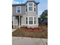 Two-story house with gray siding, landscaping, and a front entrance at 4530 Brook Hollow Cir, Winter Springs, FL 32708