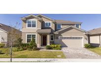 Two-story house with a two-car garage and landscaped front yard at 1798 Flourish Ave, Kissimmee, FL 34744
