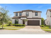Two-story house with a brown door and garage at 218 Brooke'S Pl, Haines City, FL 33844