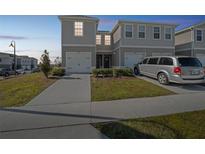 Two-story townhouse with driveway and garage at 251 Blueberry Ln, Davenport, FL 33837
