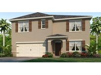 Two-story house with neutral siding, brown accents, and a two-car garage at 437 Caraway Dr, Kissimmee, FL 34759