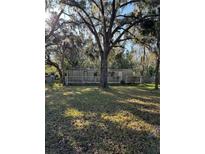Mobile home with deck, situated on a spacious lot with mature trees at 15924 Old Cheney Hwy, Orlando, FL 32833
