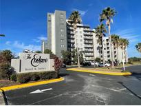 Hotel exterior with palm trees and ample parking at 6165 Carrier Dr # 2401, Orlando, FL 32819