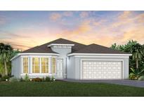 Two-story house with a two-car garage and landscaping at 1104 Western Blue Way, Minneola, FL 34715