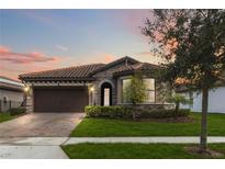 Charming one-story home with stone accents and a brown garage door at 11637 Meadow Grove Cir, Orlando, FL 32836