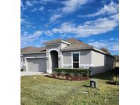 One-story home with attached garage and landscaped lawn at 3509 Yarian Dr, Haines City, FL 33844