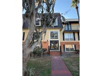 Attractive condo building exterior with landscaping and walkway at 4136 Versailles Dr # 4136D, Orlando, FL 32808