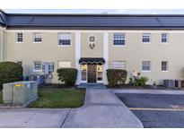 Condo building exterior featuring a classic design, landscaping, and ample parking at 1500 Gay Rd # 7A, Winter Park, FL 32789