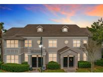 Attractive two-story townhome with a charming front porch and landscaping at 5269 Wellington Park Cir # 23, Orlando, FL 32839