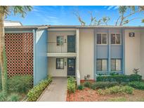 Two-story condo building with light blue exterior and walkway at 2 Escondido Cir # 190, Altamonte Springs, FL 32701