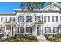 White townhouses with gray shutters and columns at 4459 Twinview Ln, Orlando, FL 32814