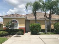 Single-story home with attractive landscaping and a paved driveway at 259 Grand Rapids Dr, Poinciana, FL 34759