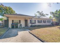 Brick house with a covered entryway, driveway, and mature landscaping at 4213 Seybold Ave, Orlando, FL 32808