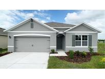 New single-story home with gray siding, two-car garage, and landscaping at 4141 Giorgio Dr, Winter Haven, FL 33884