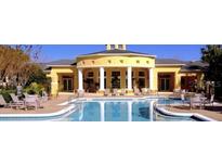 Community pool with clubhouse and surrounding lounge chairs at 2598 Robert Trent Jones Dr # 1010, Orlando, FL 32835