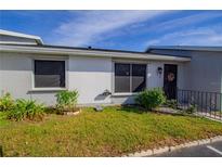 Front view of a condo with well-maintained landscaping at 79 Lake Villa Way, Kissimmee, FL 34743